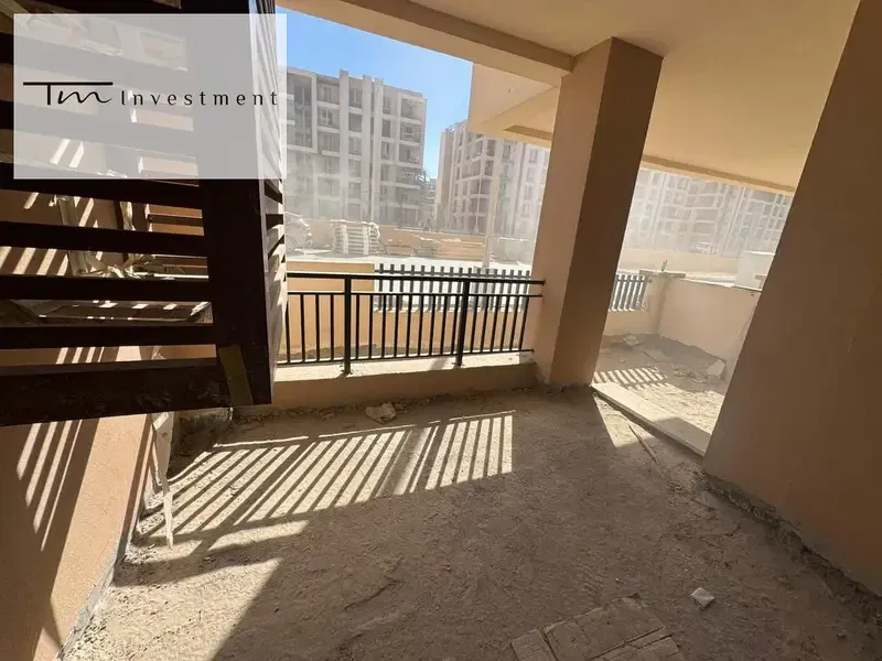 A ground floor apartment with a garden,Gate 2 of the airport, in installments over 4 years, in Taj Sultan on the Suez Road, New Cairo