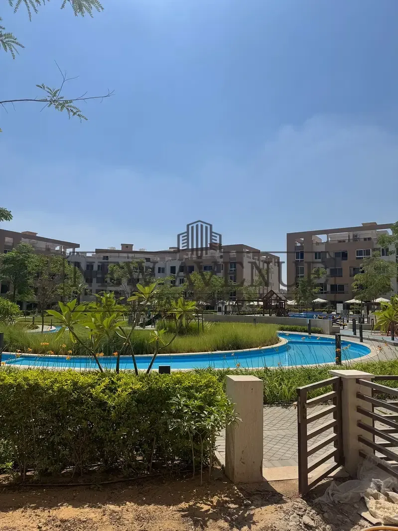 Very prime location view direct on water features and greenery with private garden - for sale in granda life Al sherouk city