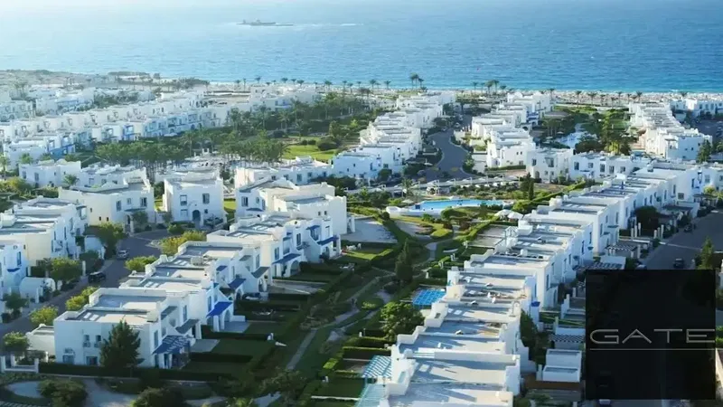 Lowest resale price: Chalet in Mountain View Ras El Hikma, Skala View Phase, with a pool on an elevated terrace.
