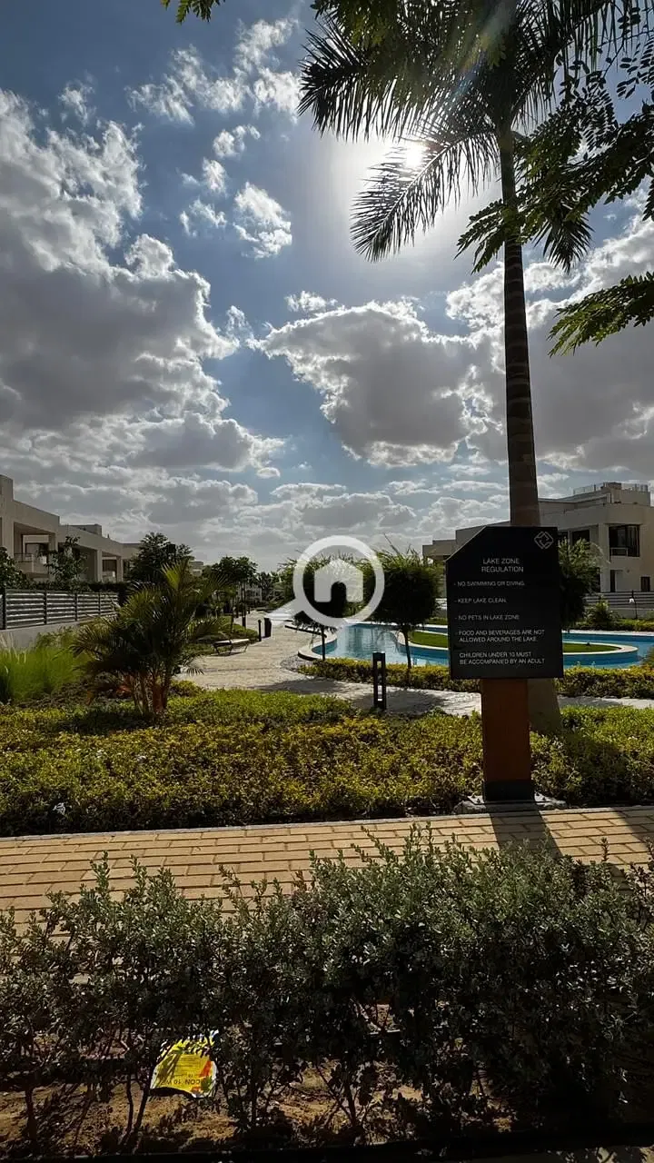 Corner townhouse villa for resale at the lowest price in Sheikh Zayed, directly in front of Beverly Hills, in Lake West Compound.